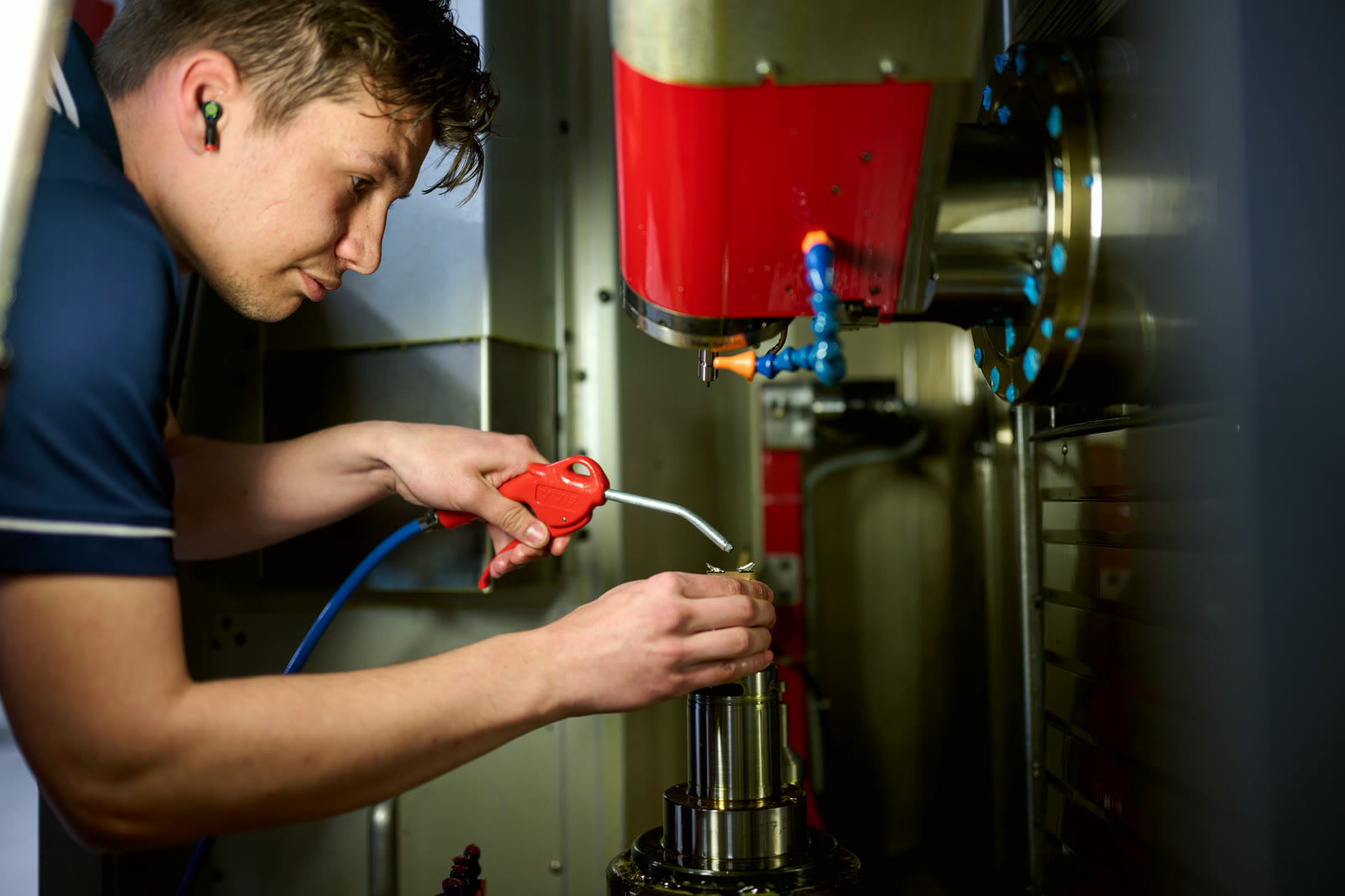 Operator setting a tool in the CNC spindle