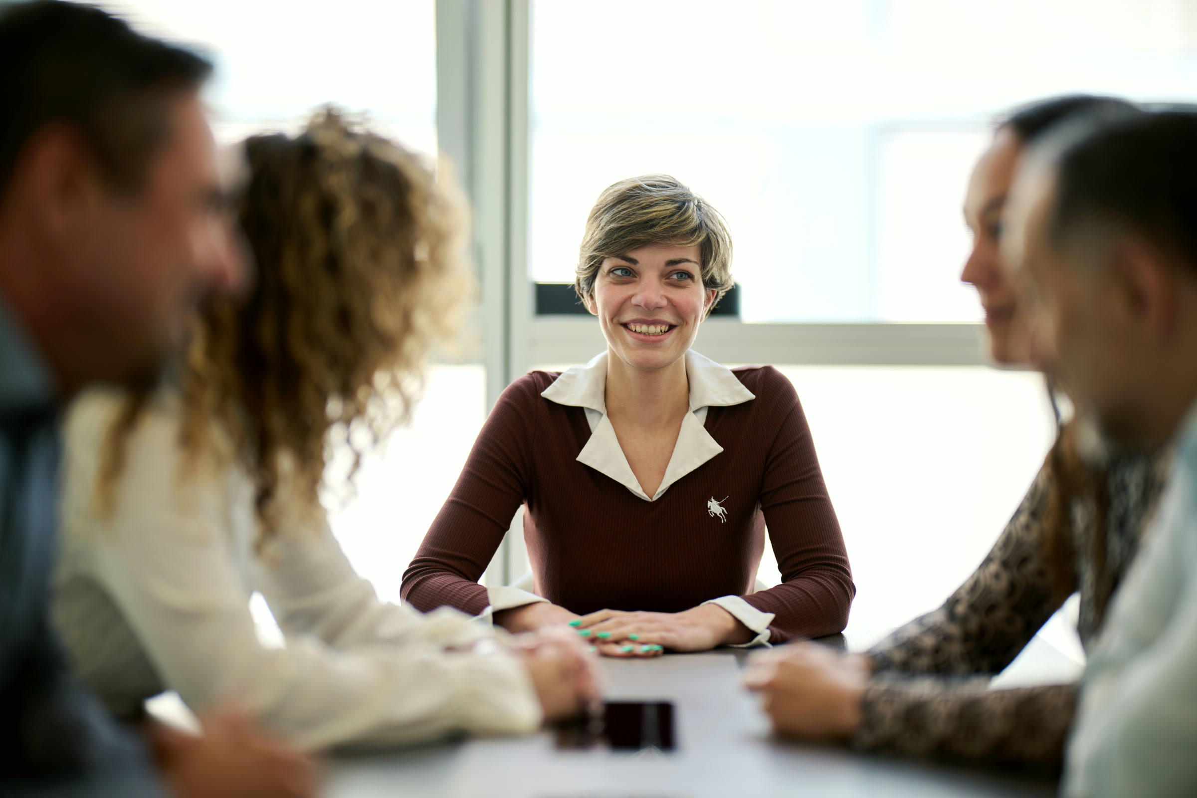 A NIRU colleague smiling with the team at the Geneva office