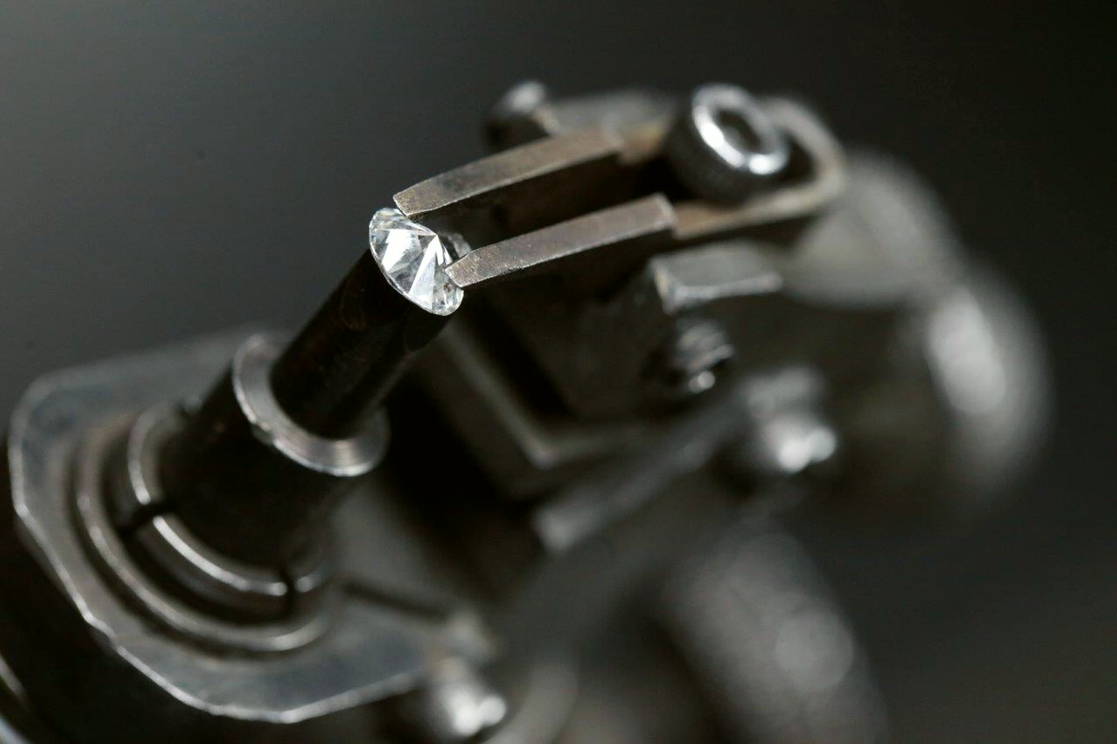 A round brilliant diamond held in the tang jaws