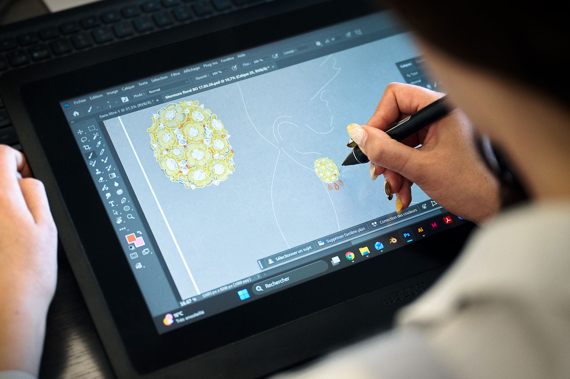 Designer sketching on a Wacom tablet in Photoshop